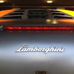 Close-up of the rear of a Lamborghini car, featuring the Lamborghini logo and an elevated brake light strip, showcasing the benefits of paint protection film.